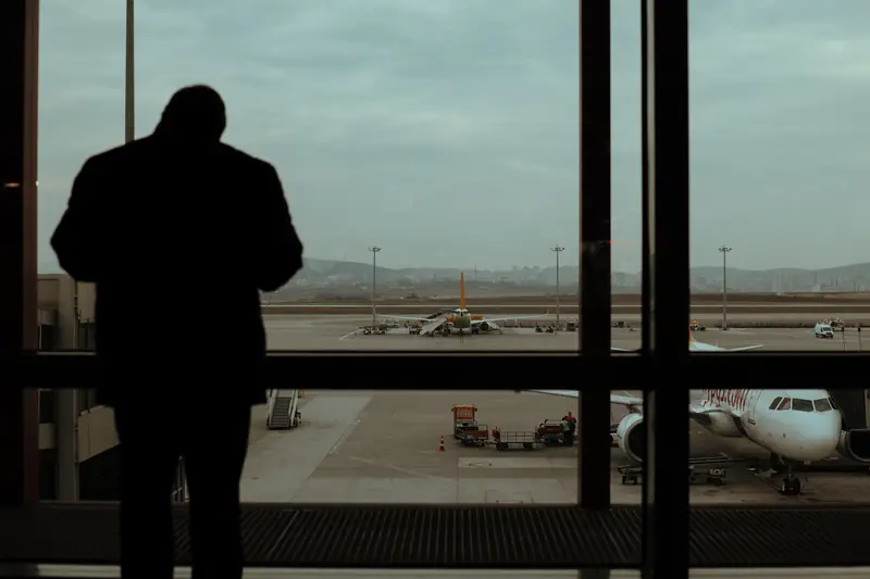 Business traveller waiting at an airport after testing games in airplane mode