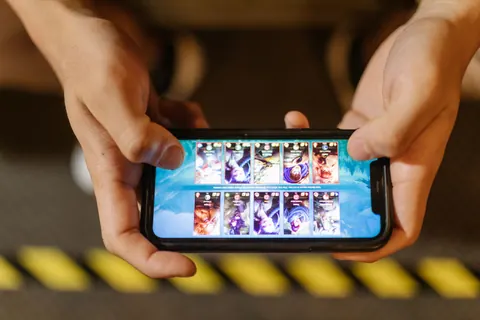 Hands playing a mobile game on a smartphone