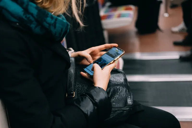 Commuter using an iPhone while waiting without dependable WiFi