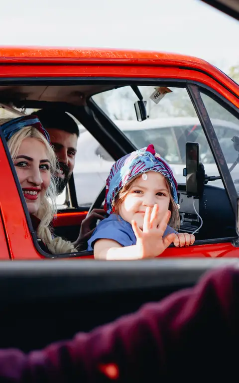 A family arriving for a road trip with offline mini games ready for the kids