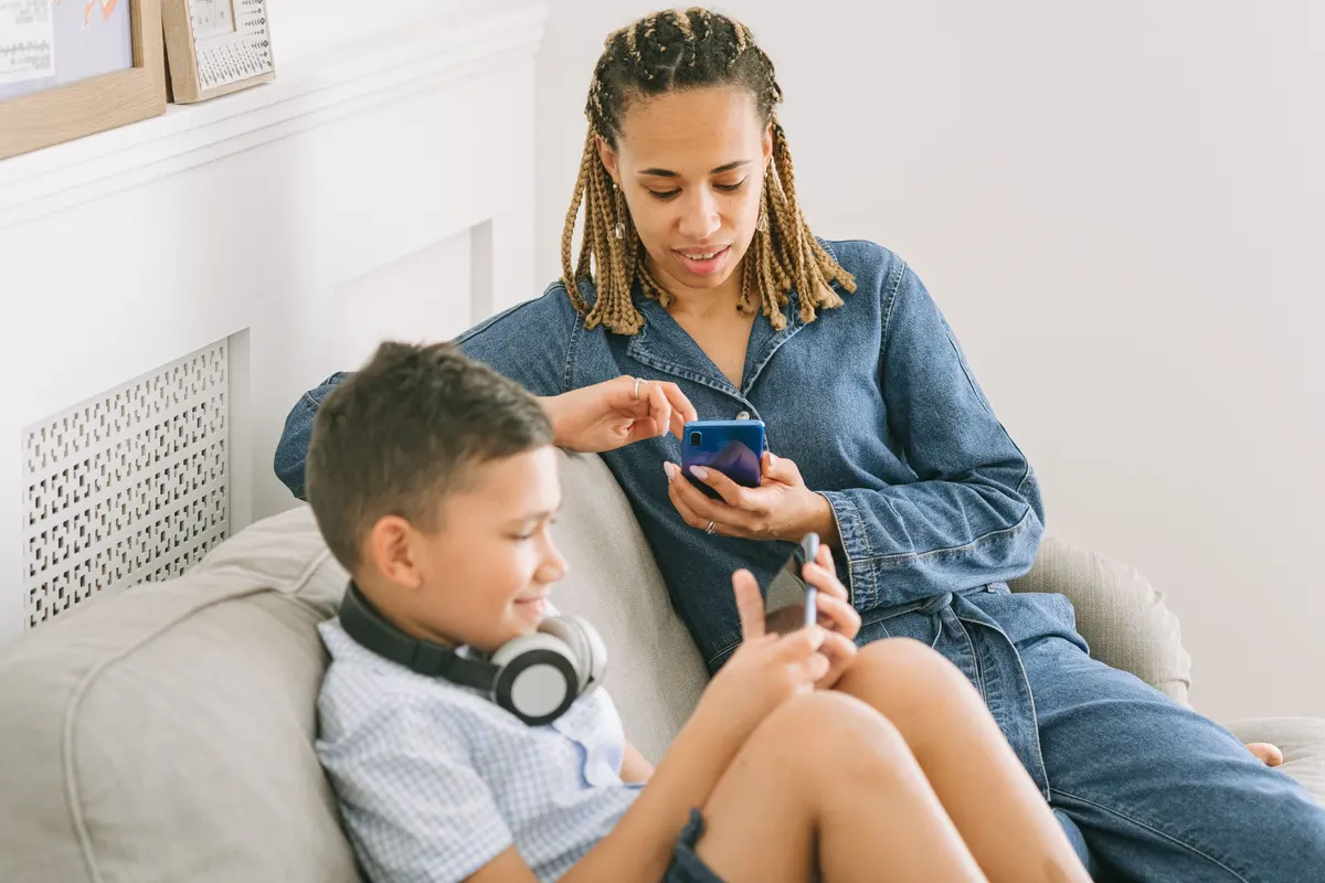 A parent and child choosing offline pass-and-play games on their phones