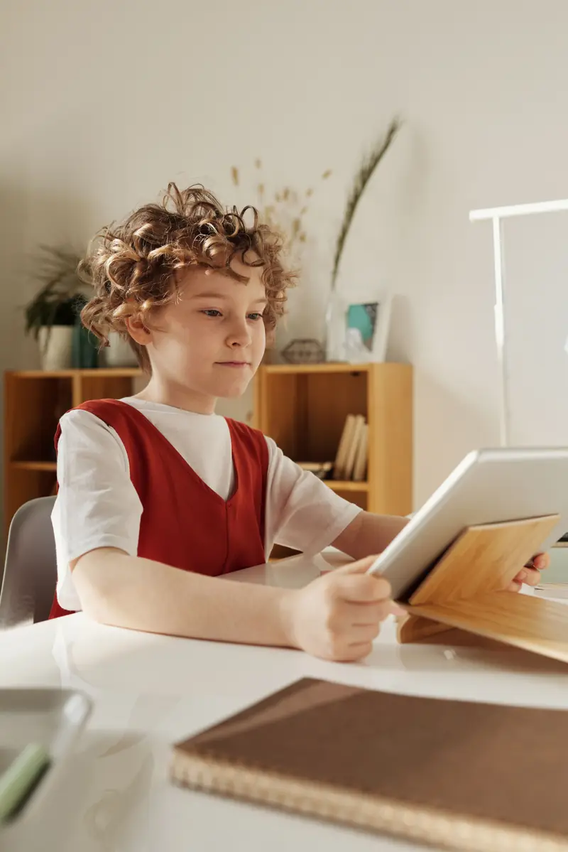 A child using a tablet for a learning game at home
