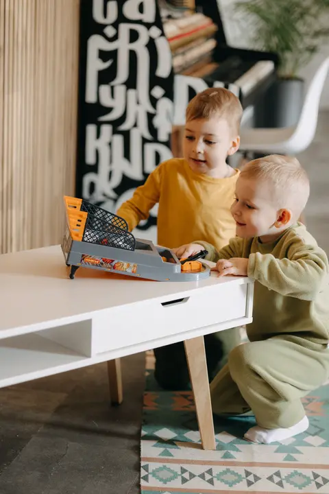 Two children playing a tabletop game together, a useful image for 2-player games for kids without internet